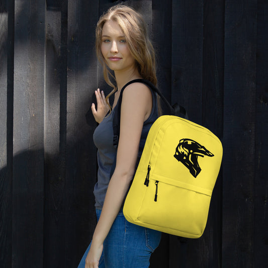 A lady wearing a yellow backpack with a black motorbike helmet design.