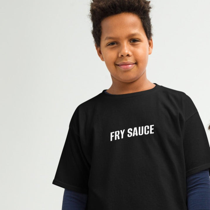 Two children, one male and one female, wearing black crew neck t-shirts with the text 'Fry Sauce' on the front, standing against a plain background.