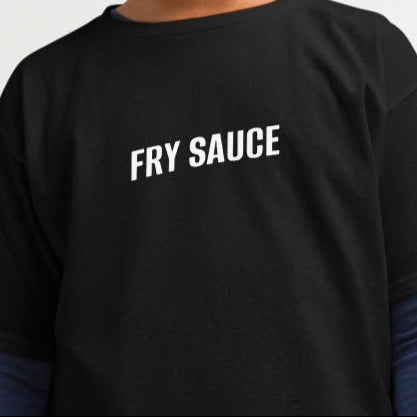 Two children, one male and one female, wearing black crew neck t-shirts with the text 'Fry Sauce' on the front, standing against a plain background.