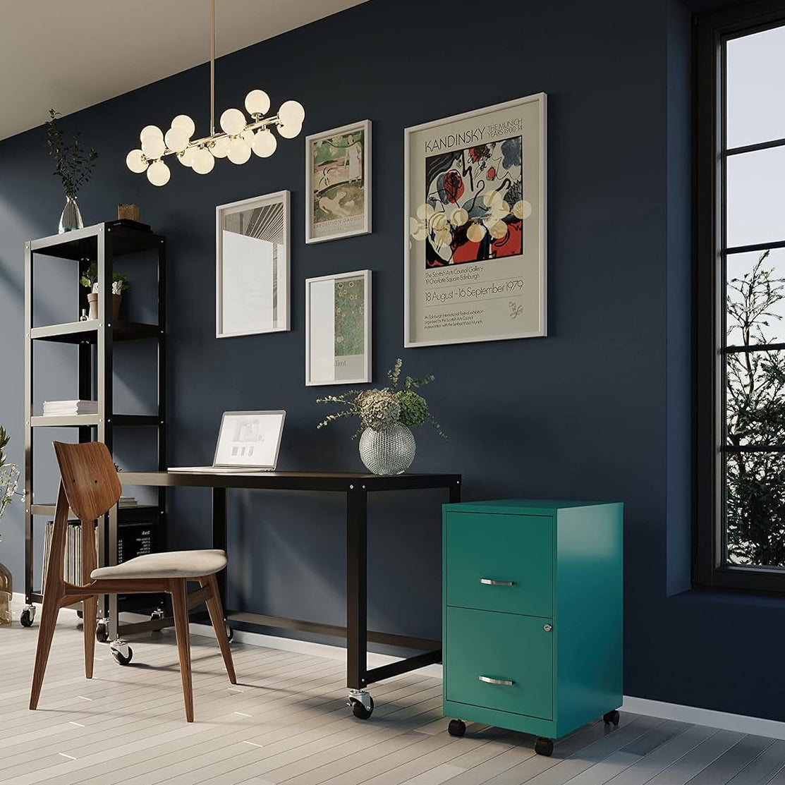 Teal filing cabinet in a modern room near a table and chair
