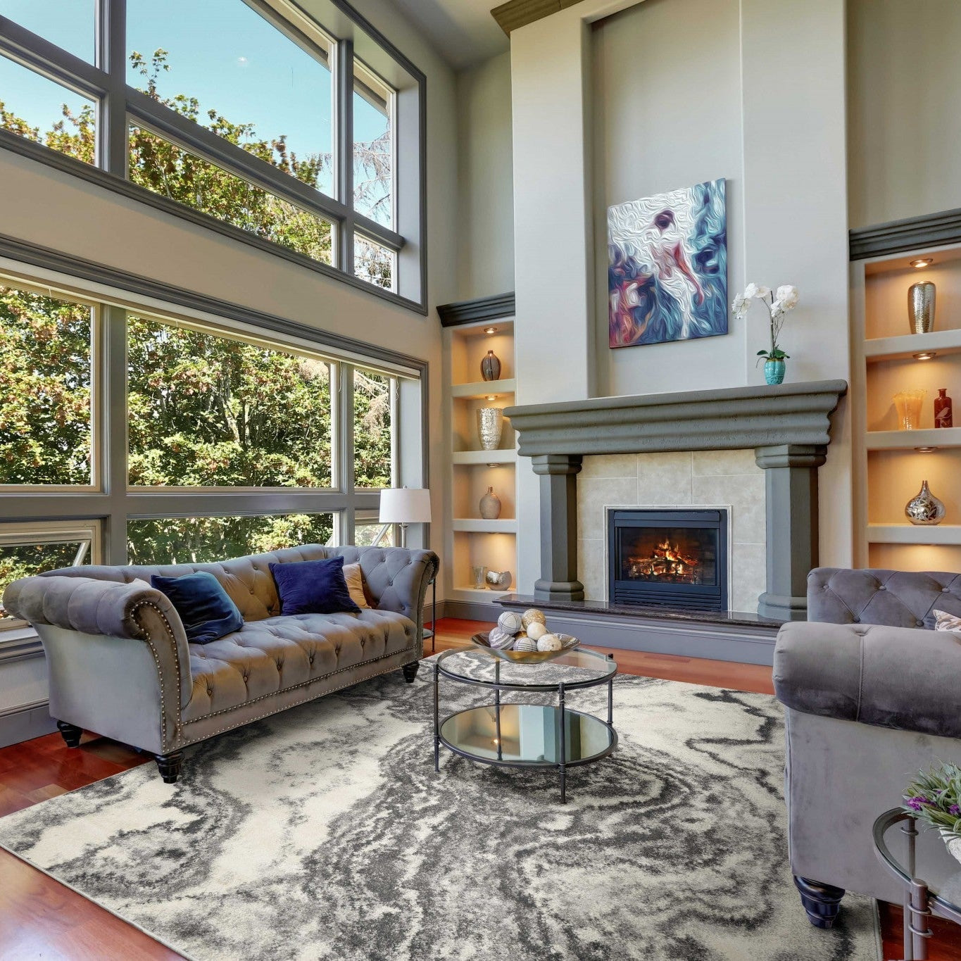 Living room with gray sofa, coffee table, and large windows.