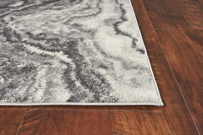 Gray and white marbled patterned rug on a wooden floor