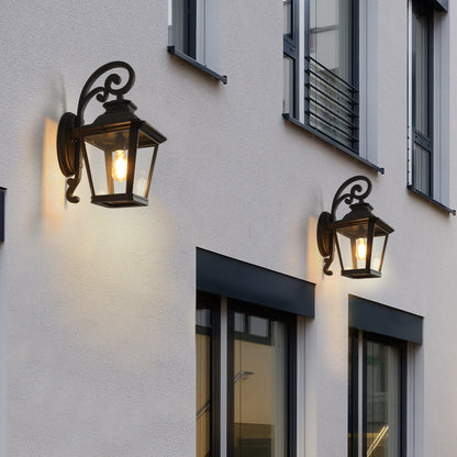 Two illuminated outdoor wall lights on a building facade.