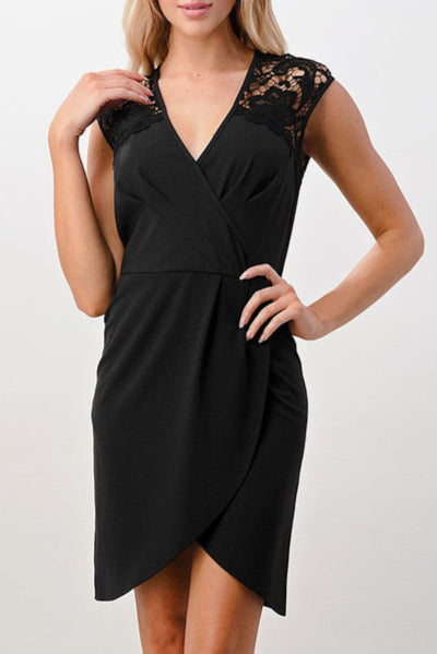 Woman wearing a black dress with lace details on a white background