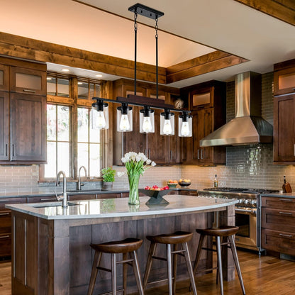 Modern kitchen with wooden cabinets, island, and pendant lights.