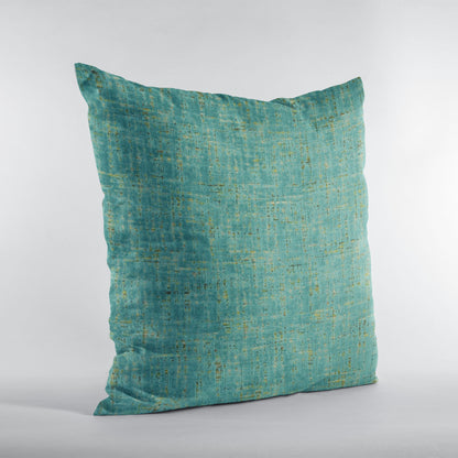 Teal textured pillow on a light gray background