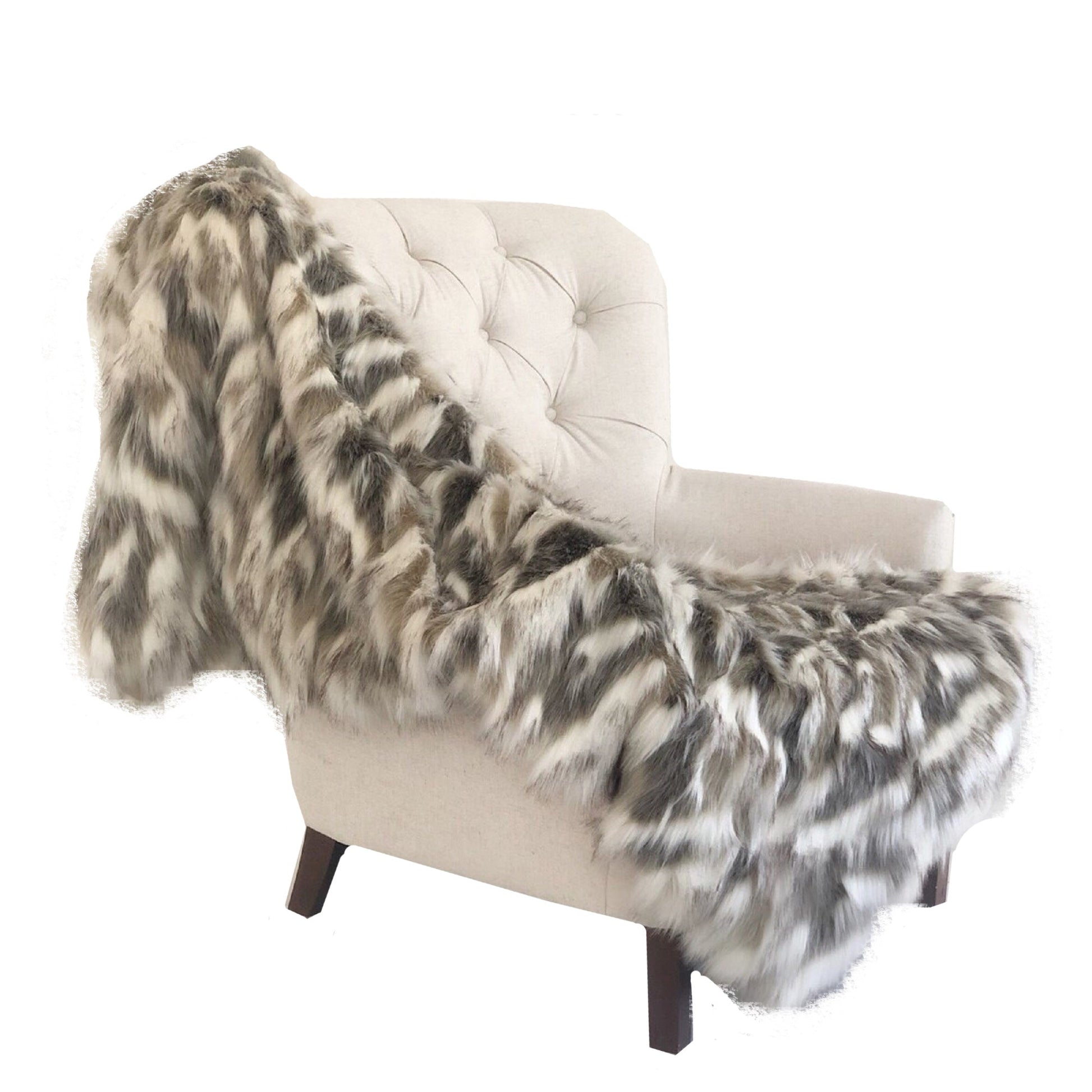 White armchair with a gray and white patterned throw blanket on a white background