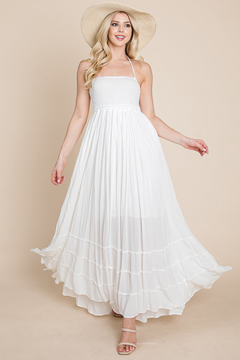 Woman wearing a white dress and beige hat 