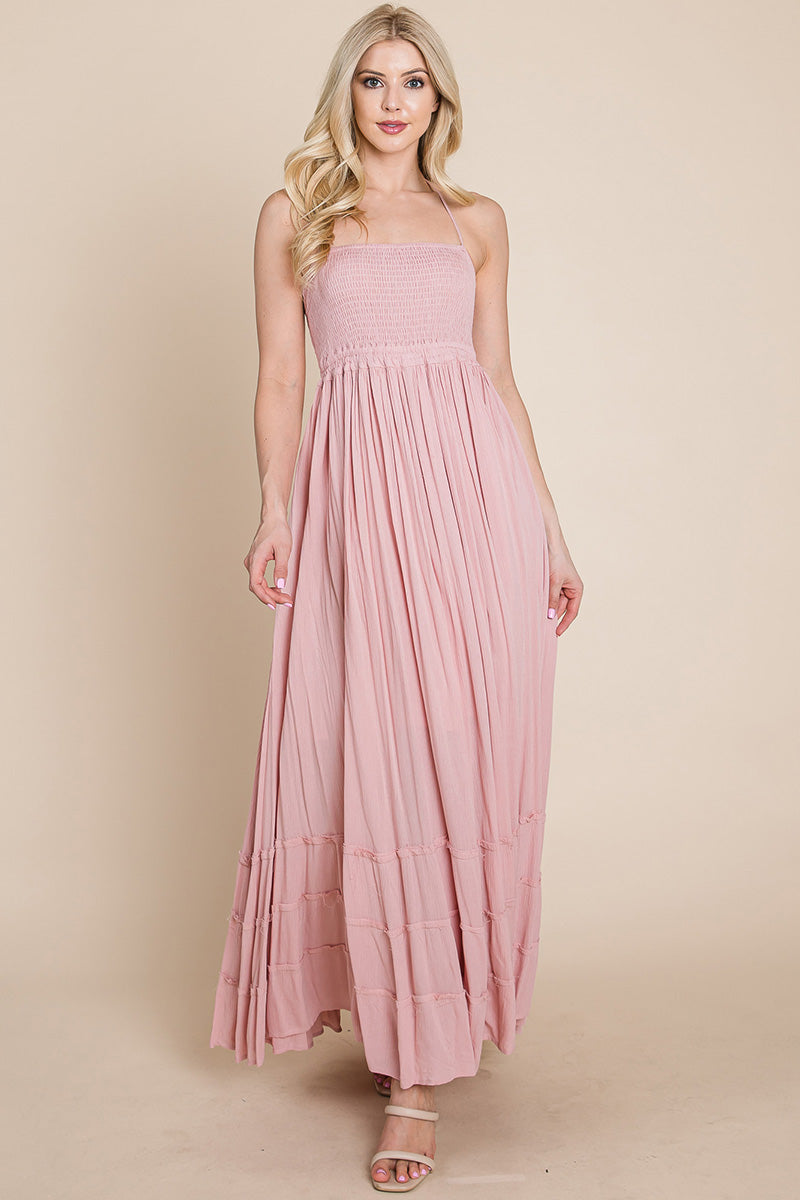 Woman wearing a pink SMOCKED BOHO MAXI WITH PLEATS & OPEN BACK