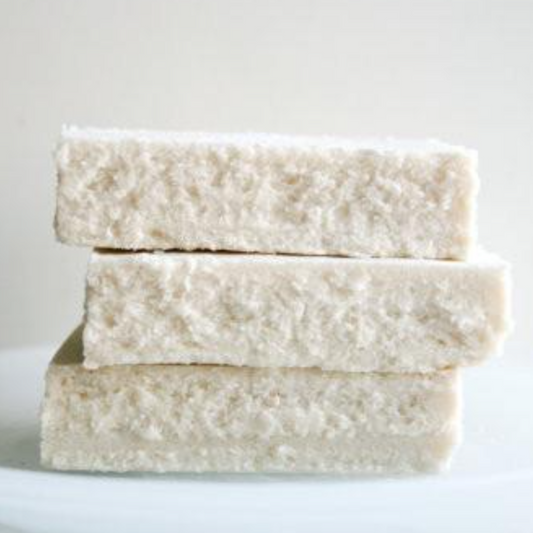 A stack of three bars of soap with a textured, exfoliating surface, reminiscent of sea salt crystals and natural ingredients.