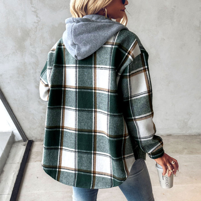 Person wearing a plaid jacket with a hood in an indoor setting