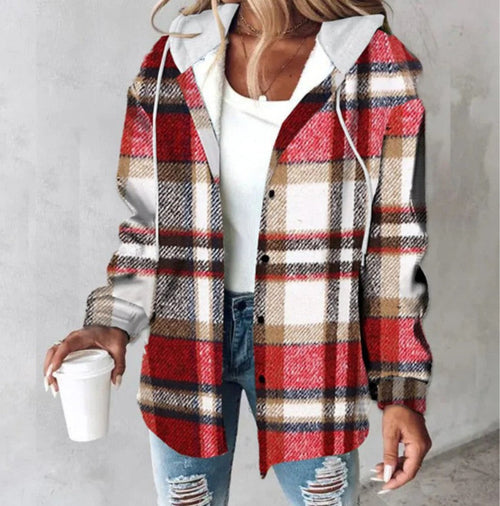 Person wearing a red and beige plaid shirt over a white hoodie, holding a coffee cup.