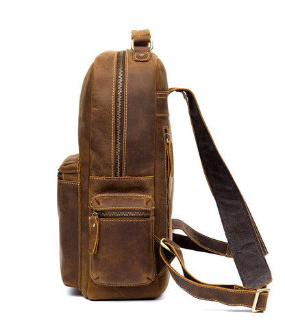 Brown leather backpack with a strap on a white background