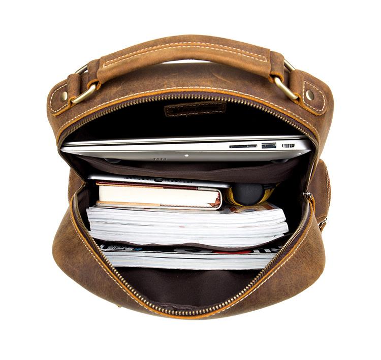 Brown leather bag with a laptop and documents inside on a white background