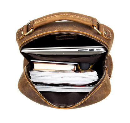 Brown leather bag with a laptop and documents inside on a white background