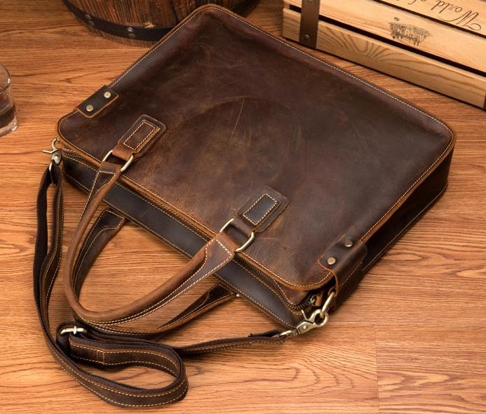 Brown leather briefcase on a wooden surface