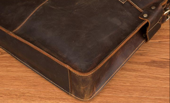 Brown leather briefcase on a wooden surface