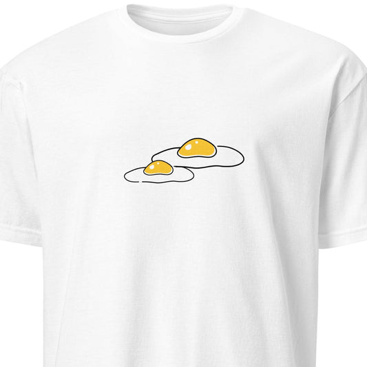 White t-shirt with a graphic of two cracked eggs on a white background